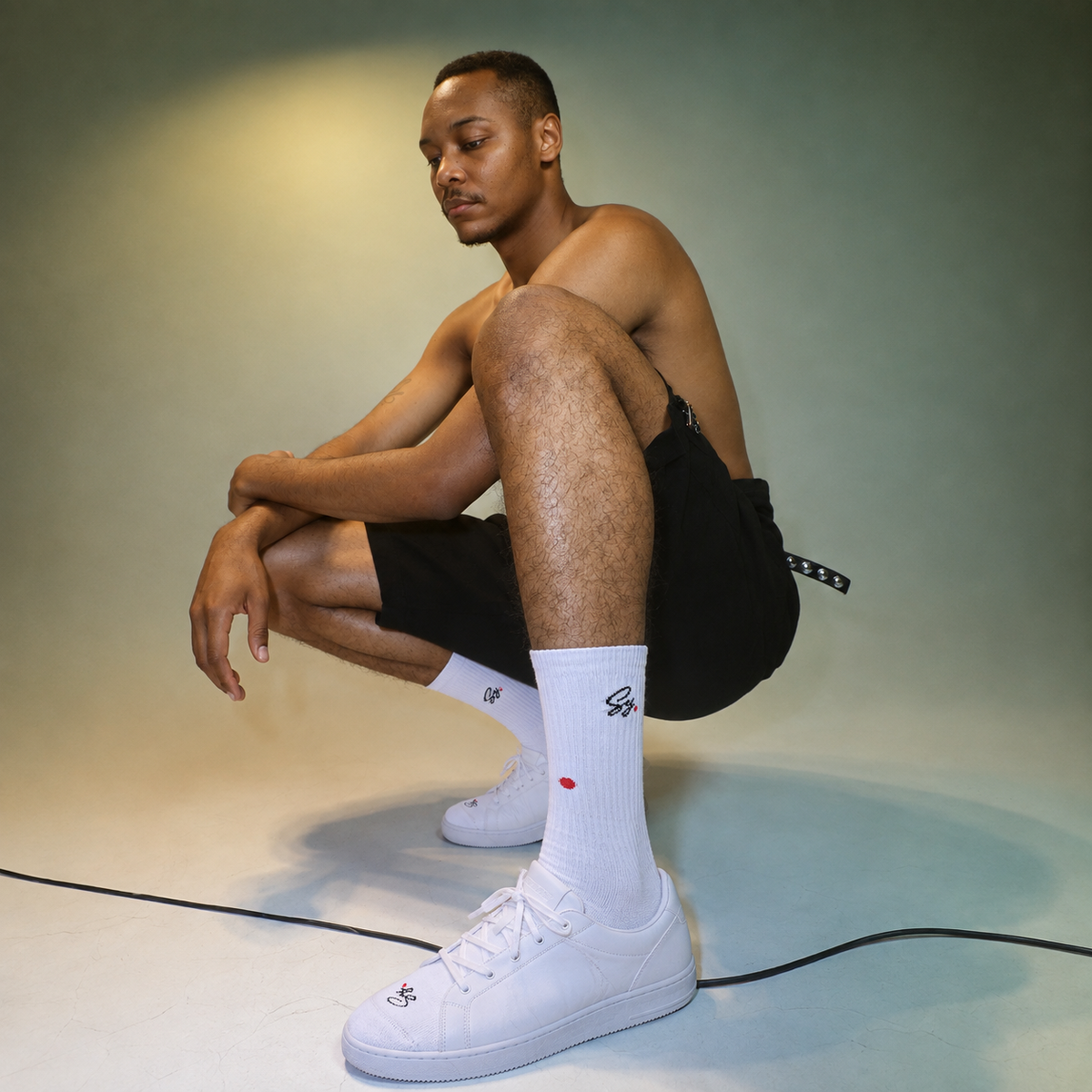 A man wearing white SY crew socks and white sneakers