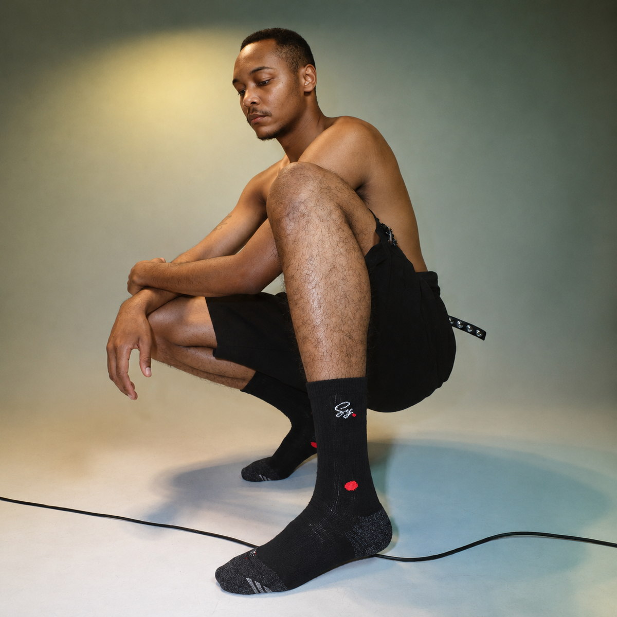 A man wearing black SY crew socks